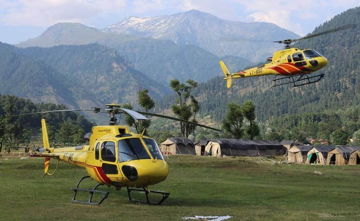 Himalayan pilgrimage helicopters waiting on lush mountain helipad
