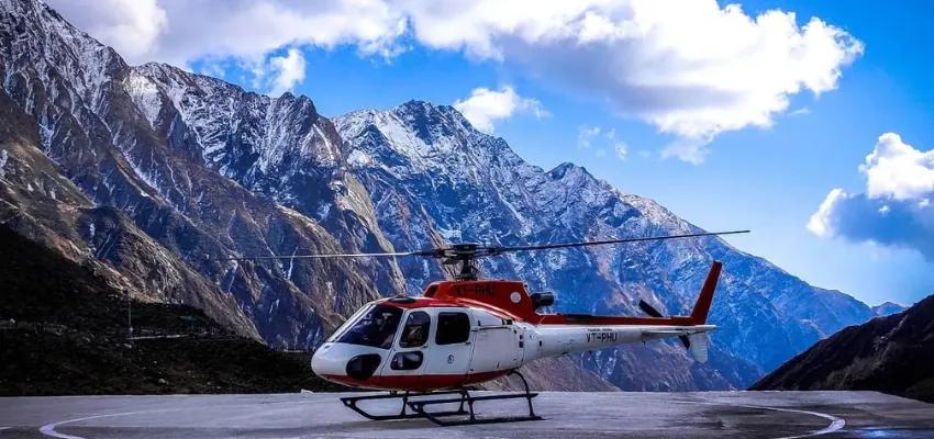Helicopter at mountain helipad overlooking Garhwal snow peaks